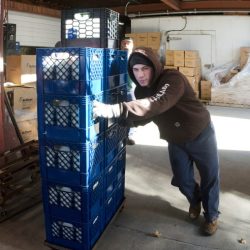 A custodian pushes a large crate